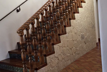 Western styled staircase with wooden spokes