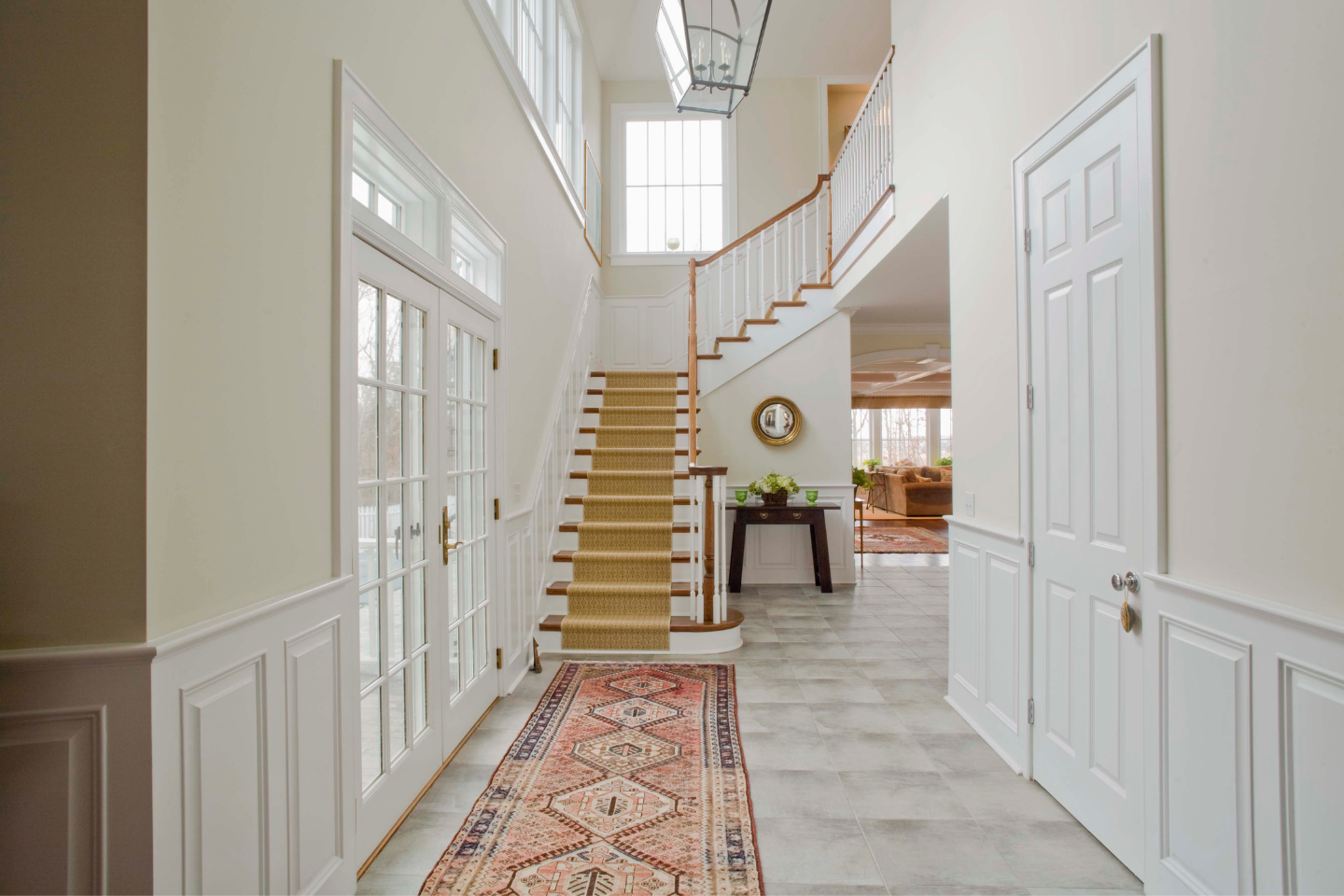 Home entryway with custom staircase design